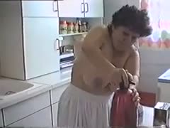 My breasty aged housewife disrobes while cleaning the kitchen